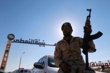 A member of Libyan forces loyal to eastern commander Khalifa Haftar holds a weapon as he sits on a car in front of the gate at Zueitina oil terminal in Zueitina, west of Benghazi, Libya September 14, 2016. PHOTO BY REUTERS/Esam Omran Al-Fetori