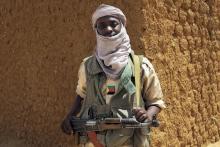 A fighter with the Tuareg separatist group MNLA (National Movement for the Liberation of Azawad) stands guard outside the local regional assembly in Kidal