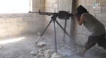 A still image taken from a video posted to a social media website by the Islamic State-affiliated Amaq News Agency, on July 15, 2017, shows a man appearing to be an Islamic State militant firing a weapon, said to be in Raqqa, Syria. PHOTO BY REUTERS/Social Media Website