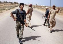 Libya Dawn fighters search for Islamic State militant positions during a patrol near Sirte, March 17, 2015. PHOTO BY REUTERS/Goran Tomasevic