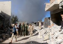 Fighters of Libyan forces allied with the U.N.-backed government gather as smokes rises following an air strike on Islamic State positions in Ghiza Bahriya district in Sirte, Libya, November 22, 2016. PHOTO BY REUTERS/Hani Amara