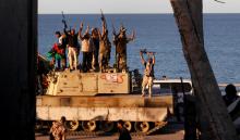 Fighters of Libyan forces allied with the U.N.-backed government celebrate after they finished clearing Ghiza Bahriya, the final district of the former Islamic State stronghold of Sirte, Libya, December 6, 2016. PHOTO BY REUTERS/Hani Amara