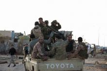 Members of forces loyal to former general Khalifa Haftar ride in a truck in the Benina area, east of Benghazi, October 24, 2014. PHOTO BY REUTERS/Stringer