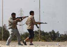 Fighters from Misrata fire weapons at Islamic State militants near Sirte, March 15, 2015. PHOTO BY REUTERS/Goran Tomasevic