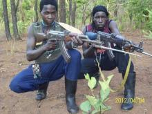 Fighters loyal to the Lord's Resistance Army (LRA) pose with their rifles inside the forest near River Mbou in the Central African Republic (CAR), April 4, 2012. PHOTO BY REUTERS