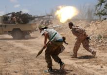 Libyan forces allied with the U.N.-backed government fire weapons during a battle with IS fighters in Sirte. PHOTO BY REUTERS/Goran Tomasevic