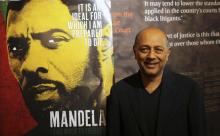 Film producer Anant Singh poses for photographs during the launch of the movie trailer of "Mandela: Long Walk to Freedom" at the Nelson Mandela Centre of Memory in Johannesburg