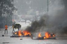 Barricades burn as rain falls during protests in Harare, Zimbabwe, January 14, 2019. PHOTO BY REUTERS/Philimon Bulawayo