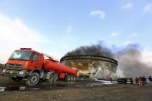 Fire-fighters work to put out a fire at a storage oil tank in the port of Es Sider, January 2, 2015. PHOTO BY REUTERS/Stringer