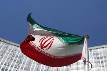 An Iranian flag flutters in front of the United Nations headquarters in Vienna