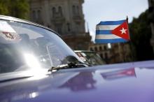 A Cuban flag flies attached on a vintage car in Havana, September 18, 2015. PHOTO BY REUTERS/Carlos Garcia Rawlins