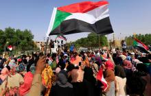 Sudanese people chant slogans and wave their national flag as they celebrate, after Sudan's ruling military council and a coalition of opposition and protest groups reached an agreement to share power during a transition period leading to elections, along the streets of Khartoum, Sudan, July 5, 2019. PHOTO BY REUTERS/Mohamed Nureldin Abdallah