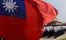 Members of the National Security Bureau take part in a drill next to a national flag at its headquarters in Taipei, Taiwan, November 13, 2015. PHOTO BY REUTERS/Pichi Chuang