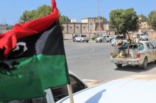 Forces aligned with Libya's new unity government advance along a road in Sirte, June 10, 2016. PHOTO BY REUTERS/Stringer