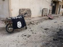 A flag belonging to the Islamic State fighters is seen on a motorbike after forces loyal to Syria's President Bashar al-Assad recaptured the historic city of Palmyra, in Homs Governorate in this handout picture provided by SANA, March 27, 2016. PHOTO BY REUTERS/SANA