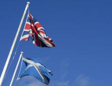 The Saltire (R) and Union Flag fly together in a street before a debate in the Scottish Parliament on ‘Scotland’s future,’ in Edinburgh, Scotland