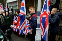 People hold the Union Flag whilst attending a Britain First rally as deputy leader Jayda Fransen (L) looks on, in Rochester, Britain, November 15, 2014. PHOTO BY REUTERS/Kevin Coombs