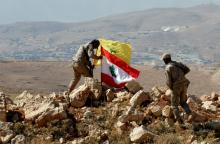Hezbollah fighters put Lebanese and Hezbollah flags at Juroud Arsal, Syria-Lebanon border, July 25, 2017. PHOTO BY REUTERS/Mohamed Azakir
