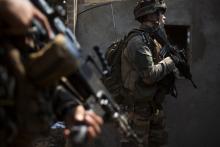 French peacekeeping soldiers search a looted house in the district of Combattant near the airport of the capital Bangui