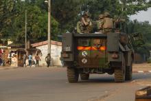 French soldiers of "Operation Sangaris" travel in a military vehicle as civilians flee from a firefight between African peacekeepers and fighters from the Christian "anti-balaka" militia at Boy-rabe in Bangui