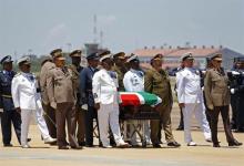 The coffin of former South African President Nelson Mandela is escorted aboard a military cargo plane after a send-off ceremony at Waterkloof Air Force base in Pretoria