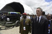 Norway's former Prime Minister Jens Stoltenberg (R) stands near the coffin of former South African President Nelson Mandela during his funeral ceremony in Qunu