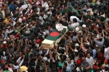 People attend a mass funeral as the body of Rajib Haider, an architect and blogger who was a key figure in organising demonstrations, arrives at Shahbagh intersection in Dhaka, February 16, 2013. PHOTO BY REUTERS/Andrew Biraj