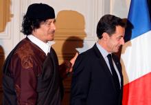 France's President Nicolas Sarkozy (R) and Libyan leader Muammar Gaddafi leave the room after the signature of 10 billion euros of trade contracts between the two countries at the Elysee Palace in Paris, December 10, 2007. PHOTO BY REUTERS/Patrick Hertzog