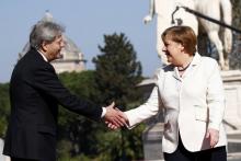 German Chancellor Angela Merkel is welcomed by Italy's Prime Minister Paolo Gentiloni outside the city hall "Campidoglio" (Capitoline Hill) as EU leaders arrive for a meeting on the 60th anniversary of the Treaty of Rome, in Rome, Italy, March 25, 2017. PHOTO BY REUTERS/Tony Gentile