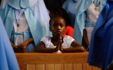 A girl prays during a service for former South African President Nelson Mandela, in the Regina Mundi Church in Soweto