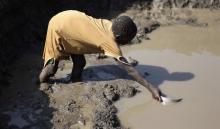 A Sudanese girl from the war-torn Blue Nile state collects water from a muddy pond, in order to avoid a 12-hour wait at a water pump, in South Sudan's Doro refugee camp December 10, 2011. PHOTO BY REUTERS/Hereward Holland