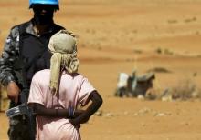 A new arrival looks at a UNIMED peacekeeper upon her arrival at the Zam Zam IDP camp, near Al Fashir in North Darfur, April 9, 2015. PHOTO BY REUTERS/Mohamed Nureldin Abdallah