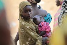 A girl carries a sleeping baby at a camp for displaced people fleeing violence from Gulak, a border town in the north of Adamawa state , Nigeria, which was attacked in September 2014, January 31, 2015. PHOTO BY REUTERS/Afolabi Sotunde