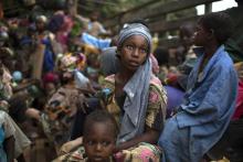 A girl sits at the back of a truck as she prepares to flee sectarian violence with other Muslim families in a convoy escorted by African Union (AU) peacekeepers towards the border with Cameroon, in the town of Bouar, west of the Central African Republic March 9, 2014. REUTERS/Siegfried Modola