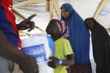 A girl fleeing violence in Nigeria receives non-food supplies after crossing the border in Ngouboua, January 19, 2015. PHOTO BY REUTERS/Emmanuel Braun