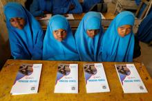 Primary school students use new textbooks during class at school that uses a new unified Somali curriculum, at Banadir zone school in Mogadishu, Somalia, September 22, 2019. PHOTO BY REUTERS/Feisal Omar