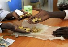 Gold mine workers wait to get their raw gold weighed at a gold shop in the town of Al-Fahir in North Darfur