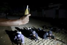 An armed vigilante holds a Soviet made hand grenade in the center of Bujumbura, Burundi, November 20, 2015. PHOTO BY REUTERS/Goran Tomasevic