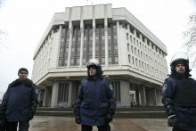 Interior Ministry members stand guard near the Crimean parliament building in Simferopol