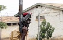 A prison officer carries a rifle at the Lira Central Prison in Northern Uganda, February 13, 2013. PHOTO BY REUTERS/Hudson Apunyo