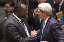 Rwanda Ambassador to the United Nations Eugene-Richard Gasana (L) greets U.S. Secretary of State John Kerry after taking part in a United Nations Security Council meeting