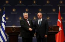 Greek Foreign Minister Nikos Kotzias (L) and his Turkish counterpart Mevlut Cavusoglu pose after a news conference in Ankara, Turkey, October 24, 2017. PHOTO BY REUTERS/Umit Bektas