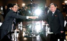 South Korean Unification Minister Cho Myoung-gyon and his North Korean counterpart Ri Son Gwon pose for photographs before their meeting at the truce village of Panmunjom, North Korea, March 29, 2018. PHOTO BY REUTERS/Korea Pool/Yonhap