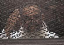 Egypt's Salafi leader and former presidential candidate Hazem Salah Abu Ismail looks on from the defendant cage during his trial in Cairo, December 19, 2013. PHOTO BY REUTERS/Stringer