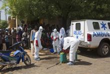 Health workers put on protective gear outside a mosque before disinfecting it, in Bamako, November 14, 2014. PHOTO BY REUTERS/Joe Penney