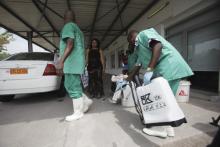 A health worker sprays a colleague with disinfectant during a training session for Congolese health workers to deal with Ebola virus in Kinshasa, October 21, 2014. PHOTO BY REUTERS/Media Coulibaly