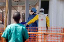 A health worker dressed in a protective suit talks to medical staff at the newly constructed MSF(Doctors Without Borders) Ebola treatment centre in Goma, Democratic Republic of Congo, August 4, 2019. PHOTO BY REUTERS/Baz Ratner