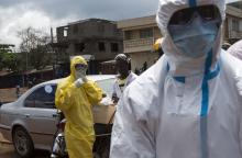 Health workers put on protective equipment near Rokupa Hospital, Freetown, October 6, 2014. PHOTO BY REUTERS/Christopher Black