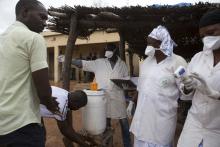 Health workers direct travellers entering Mali from Guinea to wash their hands at the border in Kouremale, October 2, 2014. PHOTO BY REUTERS/Joe Penney