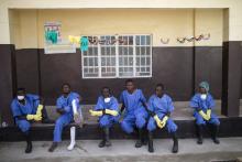 Health workers rest outside a quarantine zone at a Red Cross facility in the town of Koidu, Kono district in Eastern Sierra Leone December 19, 2014. PHOTO BY REUTERS/Baz Ratner